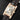 Angled front view of the curved 18k rose gold case, Roman numerals, and blued-steel hands on the Cartier Tank Americaine W2609156
