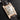 Perspective view displaying the silver guilloche dial, date window at 6 o'clock, and sapphire cabochon crown on the Cartier Tank Americaine