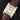 An angled studio top-down view of the Cartier Tank Normale highlighting its satin-brushed gold case borders and brown leather strap
