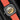 Rear studio view showing the display caseback revealing the automatic movement with its golden wheel-rim-motif rotor and anniversary laurel stamp