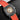 close-up studio portrait focusing on the open-worked skeleton dial layout, golden central wheel rim design, and red racing numeric tracks