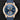 direct close-up studio front portrait of the 44.6mm 18k red gold IWC Portugieser Yacht Club Moon & Tide watch featuring a blue dial on a watch stand