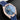 Direct front view showing the blue teak dial, 6 o'clock date window, and 18k Sedna gold markers on the Omega Aqua Terra 41mm