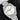 direct front studio shot of the Omega Railmaster watch tilted slightly right showcasing the vertically brushed slate grey dial and beige triangle indices