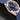 Side angle view highlighting the 18k rose gold case profile and integrated blue structured rubber strap on the Omega Aqua Terra
