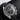 studio portrait focusing on the black dial, bi-compax sub-dials, date aperture and tachymeter bezel scale