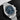 A close-up studio portrait focusing on the sunray blue dial, iconic broad arrow hands, and two sunken chronograph sub-dials
