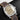 direct front studio shot of the Panerai PAM00662 watch tilted slightly right showcasing the matte brown dial, gold alpha hands, and sandwich indices
