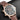 close-up studio shot focusing on the brown sunburst dial, glowing numerals, and the crisp white Tiffany & Co. logo stamp at 6 o'clock