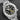 Front-angled view highlighting the black dial face, highly legible Lumibrite index markers, date window, and analog power reserve indicator scale