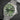 Angled profile view of a green TAG Heuer Aquaracer 300 titanium watch showcasing the matte green ceramic unidirectional rotating 12-sided dive bezel