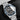 studio portrait focusing on the matte black dial, silver dial text, white luminescent snowflake indicators, and midnight blue bezel scale