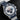 studio portrait focusing on the white and blue panda dial, red hands, triple timing registers, and date window at 6 o'clock