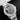 studio portrait focusing on the open-worked skeleton dial, large blue central X architecture, and silicon oscillator assembly