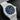 close-up studio shot focusing on the blue architectural star-patterned openwork dial, rhodium-plated indices, and 1/10th of a second counter at 6 o'clock